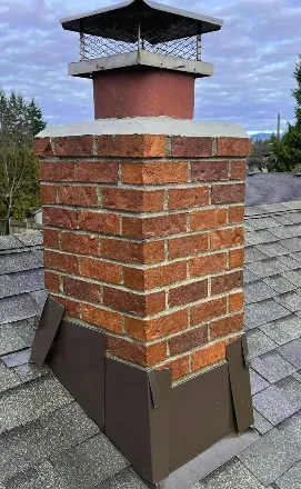 Restored brick chimney with new cap and flashing