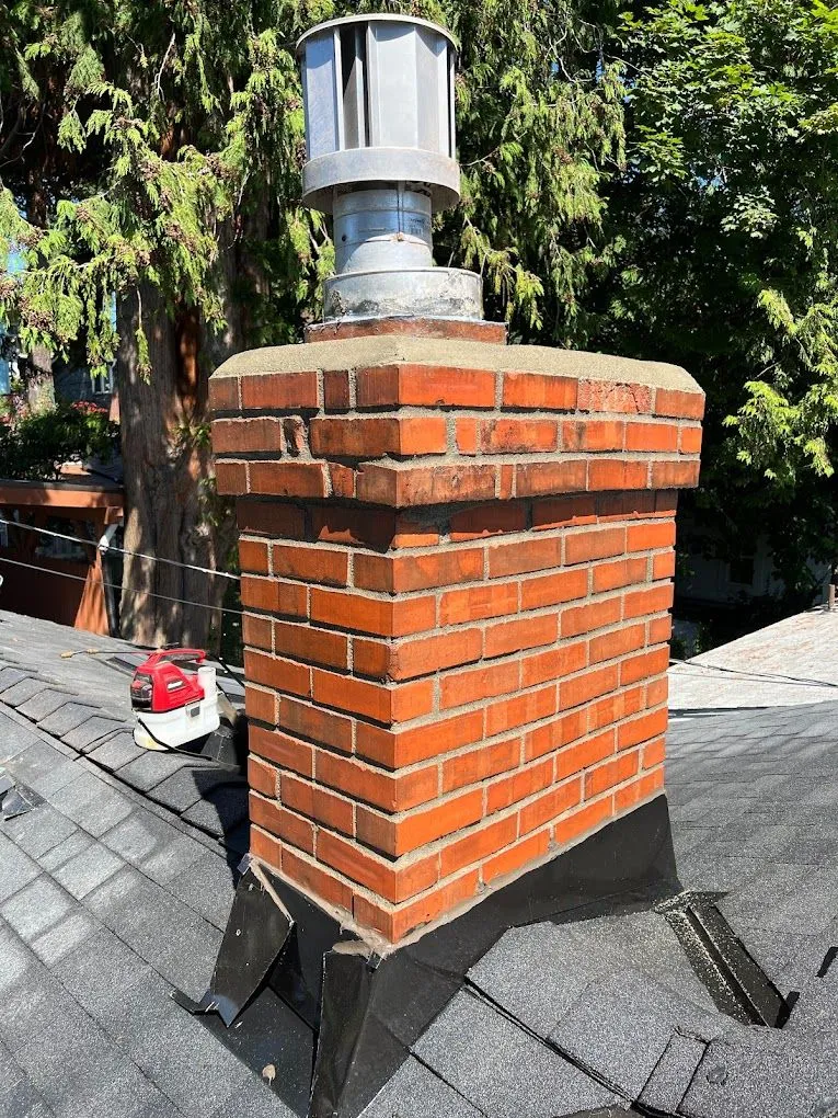 Brick chimney rebuild with new metal cap