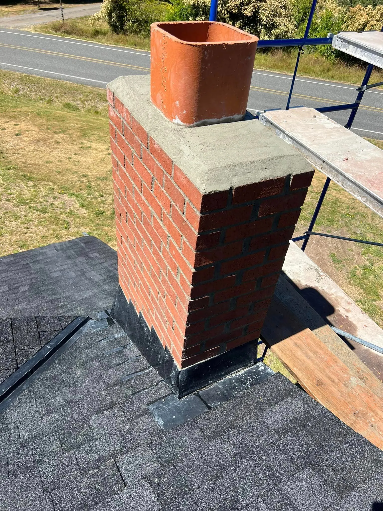 Brick chimney rebuild with new clay flue and scaffold